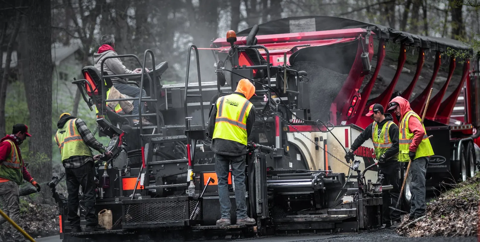 Workers using a Construction & Road Building Trailer