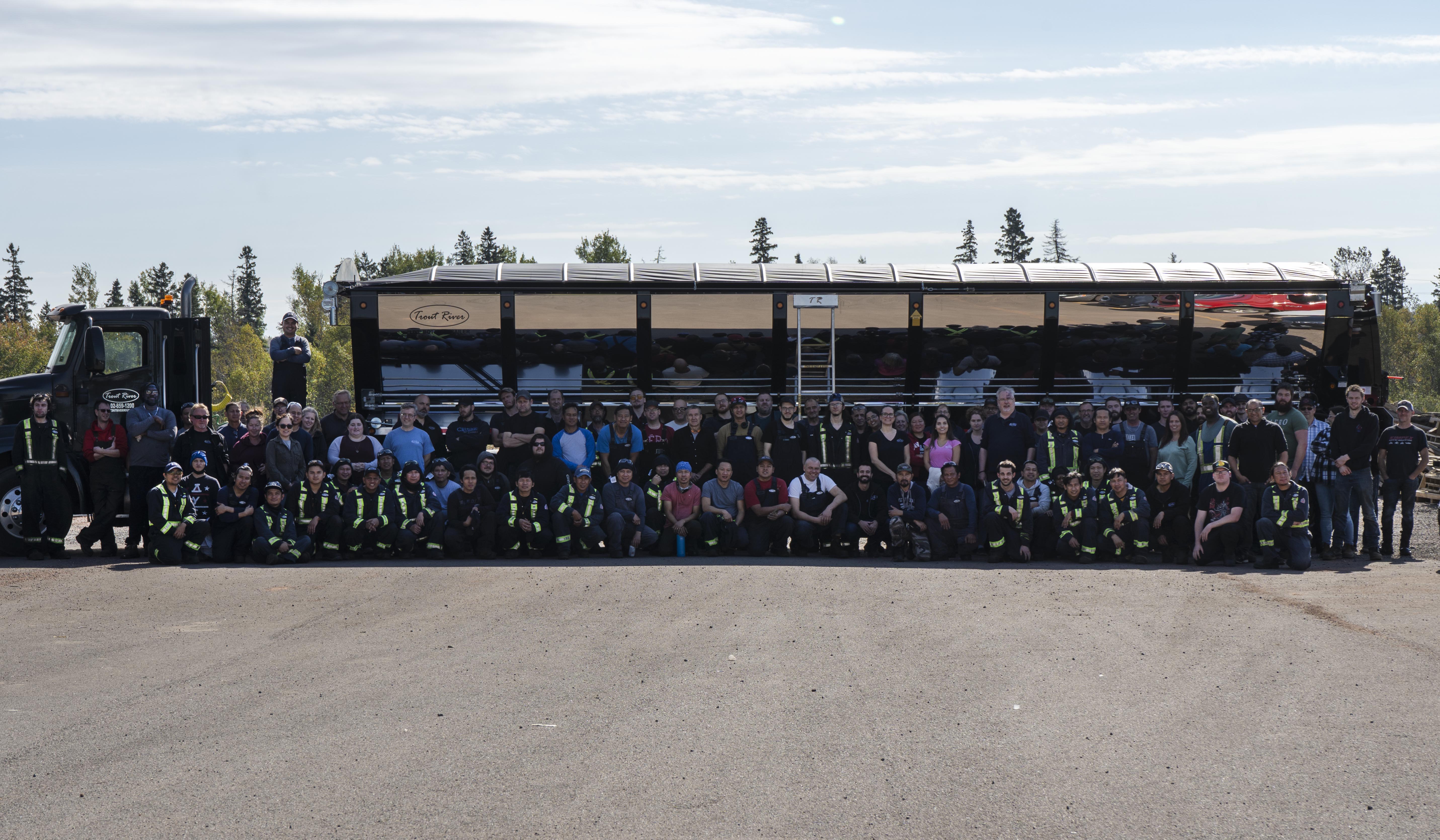 Trout River Industries Team in front of a Truck